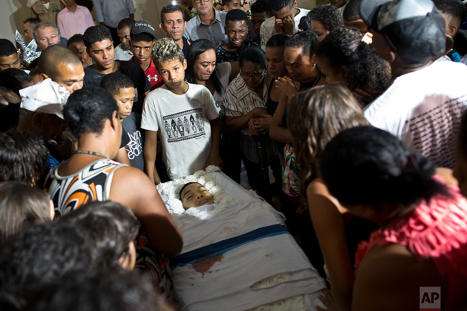  Relatives and friends of Marcos Vinicius da Silva attend his wake in Rio de Janeiro, Brazil, June 21, 2018. Da Silva is one of two 14-year-olds killed by stray bullets in Rio on Wednesday. (AP Photo/Silvia Izquierdo) 