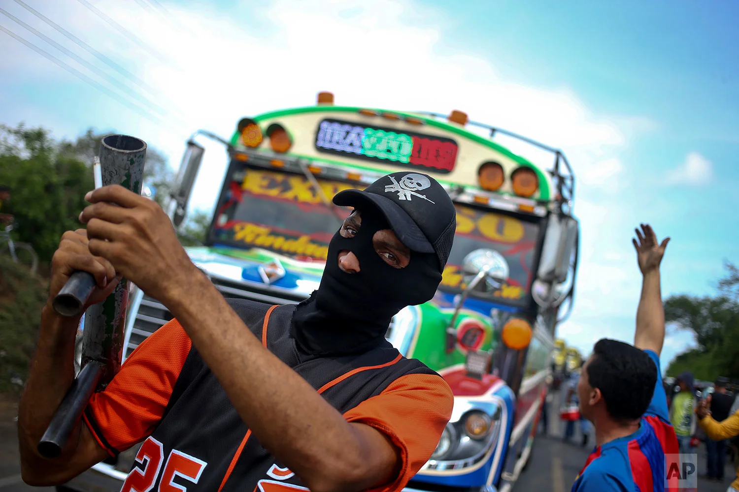 In this May 24, 2018 photo published in June, an anti-government protester holds up his homemade mortar made of sections of pipes at a roadblock set up by protesters along the Panamerican Highway in Nagarote, Nicaragua. (AP Photo/Esteban Felix)