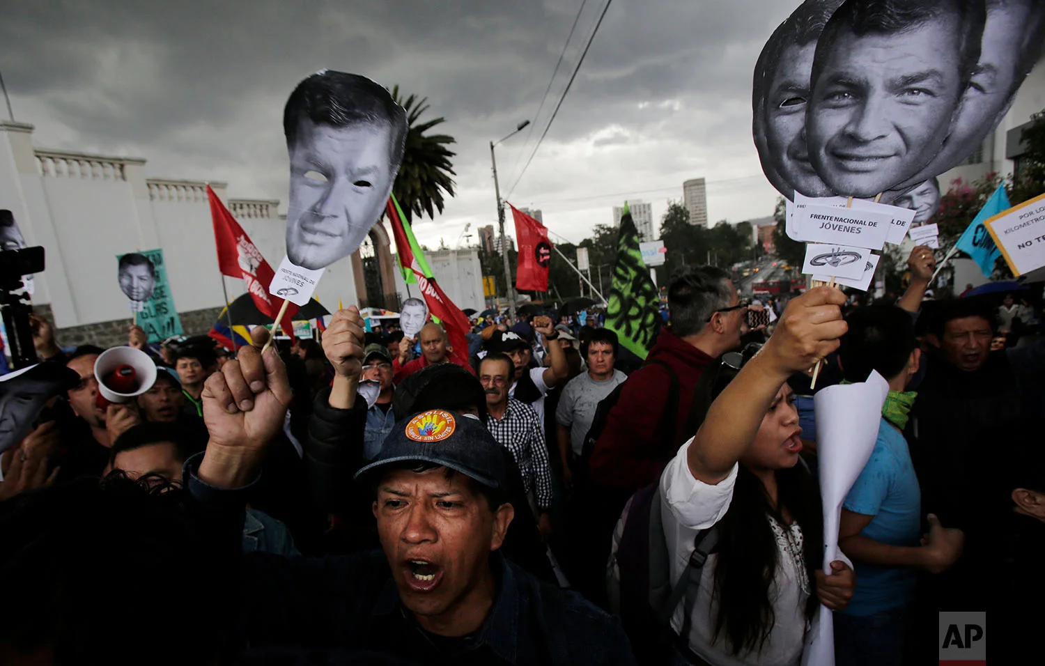 Supporters of Ecuador's former President Rafael Correa hold up his image to protest an attempt to prosecute him in connection with the attempted kidnapping of opposition lawmaker, in Quito, Ecuador, June 14, 2018. (AP Photo/Dolores Ochoa)