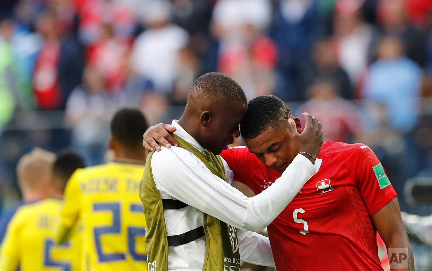 Switzerland's Manuel Akanji, right, reacts at the end of the match after Sweden defeated Switzerland during the round of 16 match between Switzerland and Sweden at the 2018 soccer World Cup in the St. Petersburg Stadium, in St. Petersburg, Russia, T