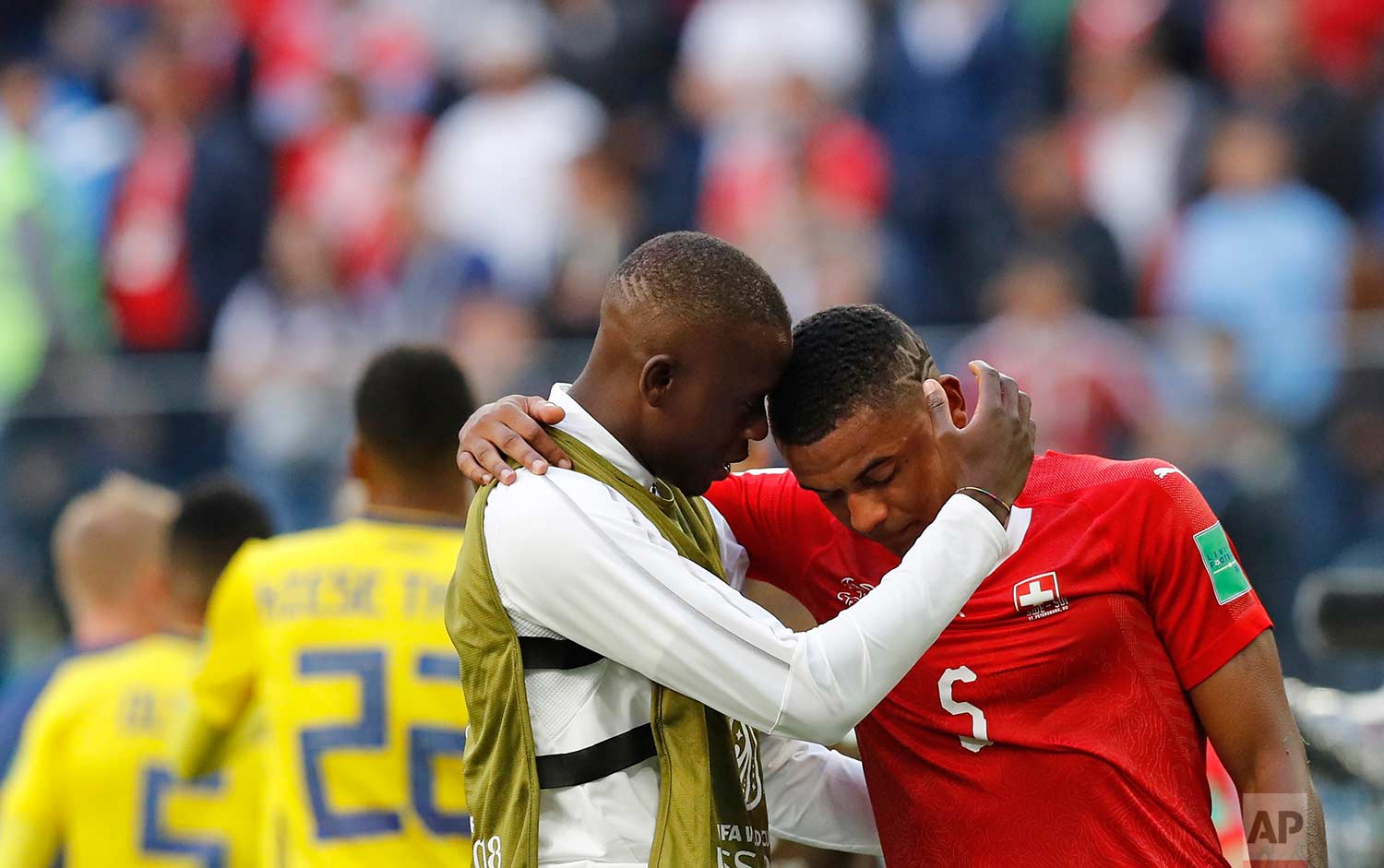  Switzerland's Manuel Akanji, right, reacts at the end of the match after Sweden defeated Switzerland during the round of 16 match between Switzerland and Sweden at the 2018 soccer World Cup in the St. Petersburg Stadium, in St. Petersburg, Russia, T