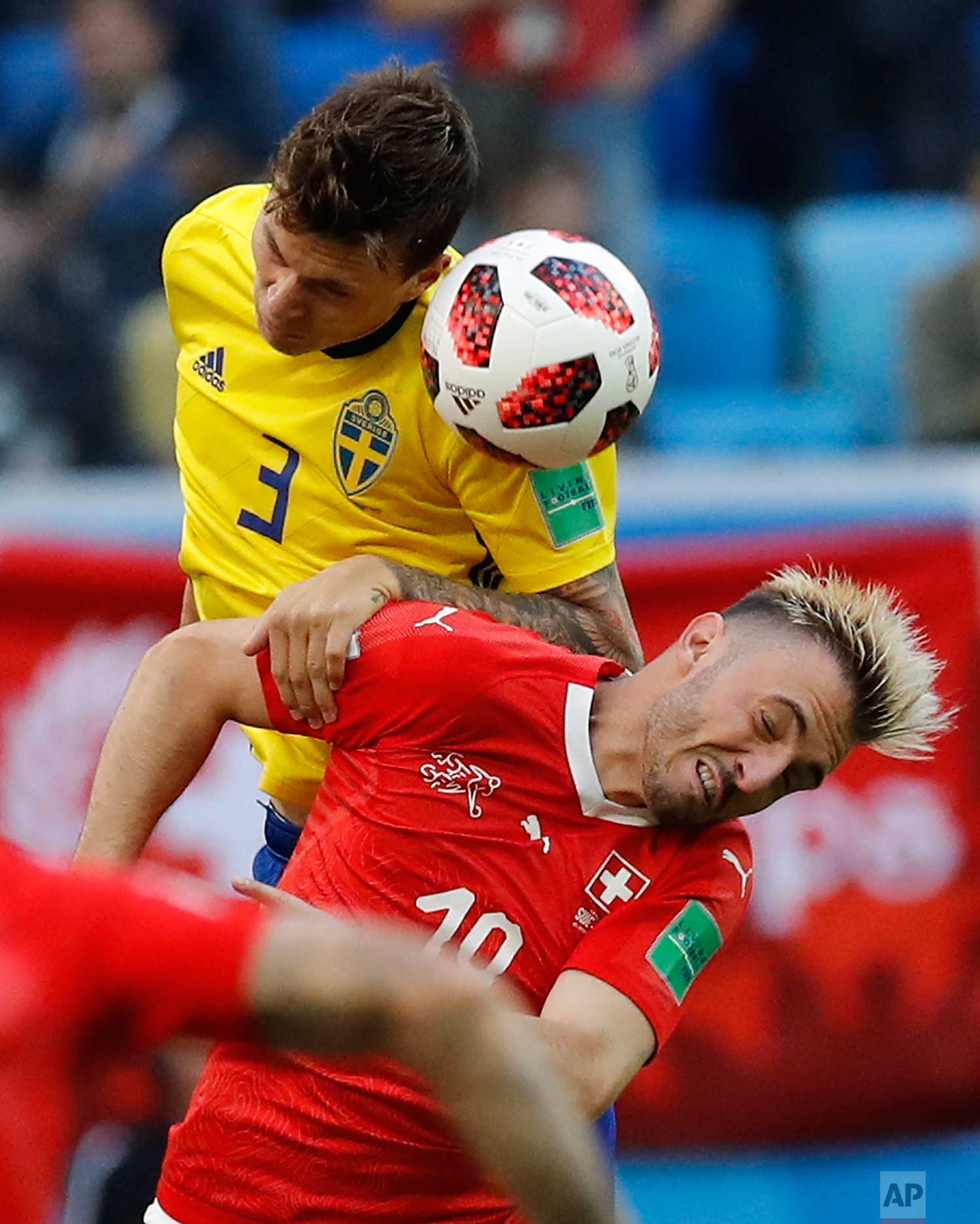  Sweden's Victor Lindelof, left, heads for the ball with Switzerland's Granit Xhaka during the round of 16 match between Switzerland and Sweden at the 2018 soccer World Cup in the St. Petersburg Stadium, in St. Petersburg, Russia, Tuesday, July 3, 20