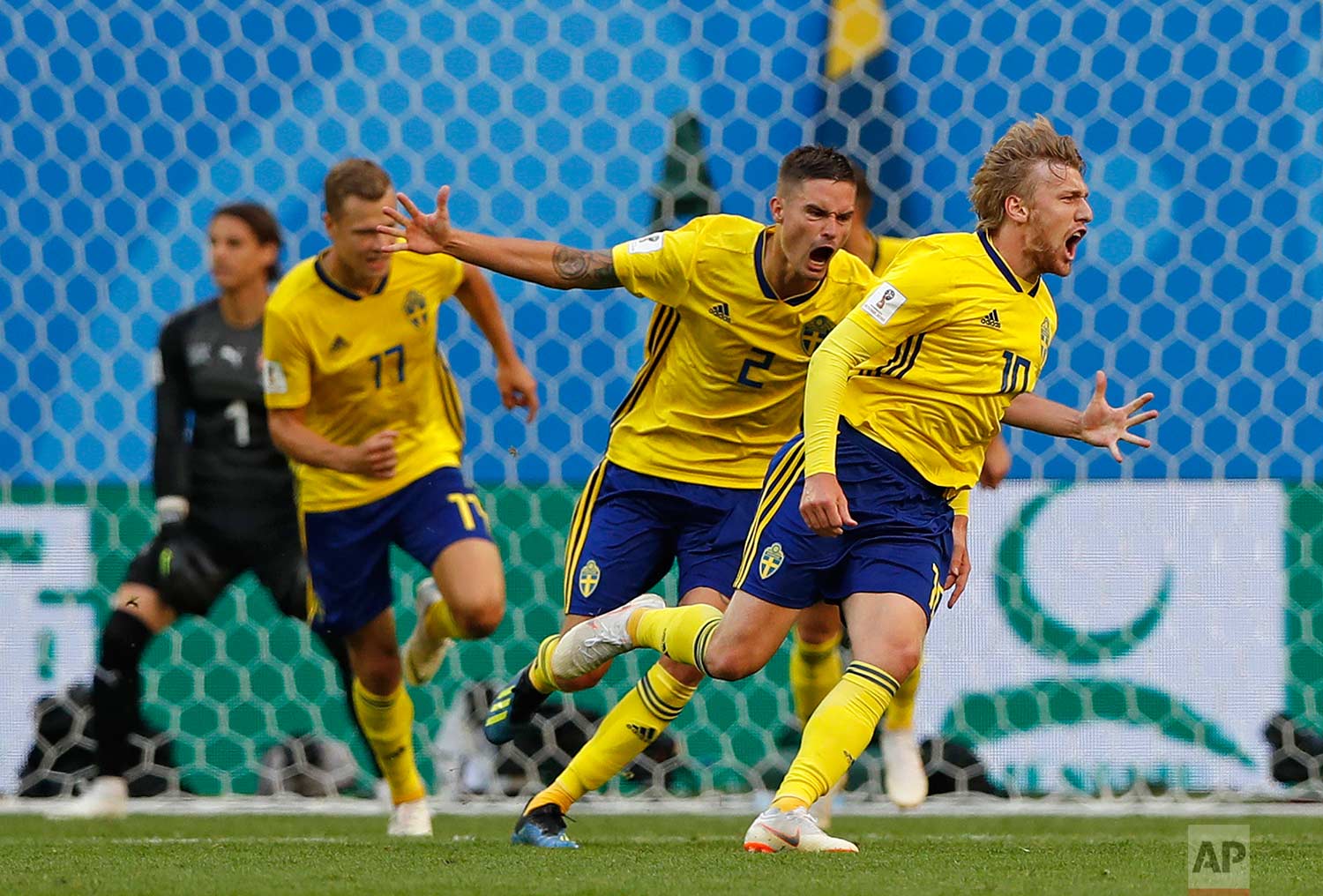 Sweden's Emil Forsberg, right, celebrates with teammates after scoring the opening goal during the round of 16 match between Switzerland and Sweden at the 2018 soccer World Cup in the St. Petersburg Stadium, in St. Petersburg, Russia, Tuesday, July
