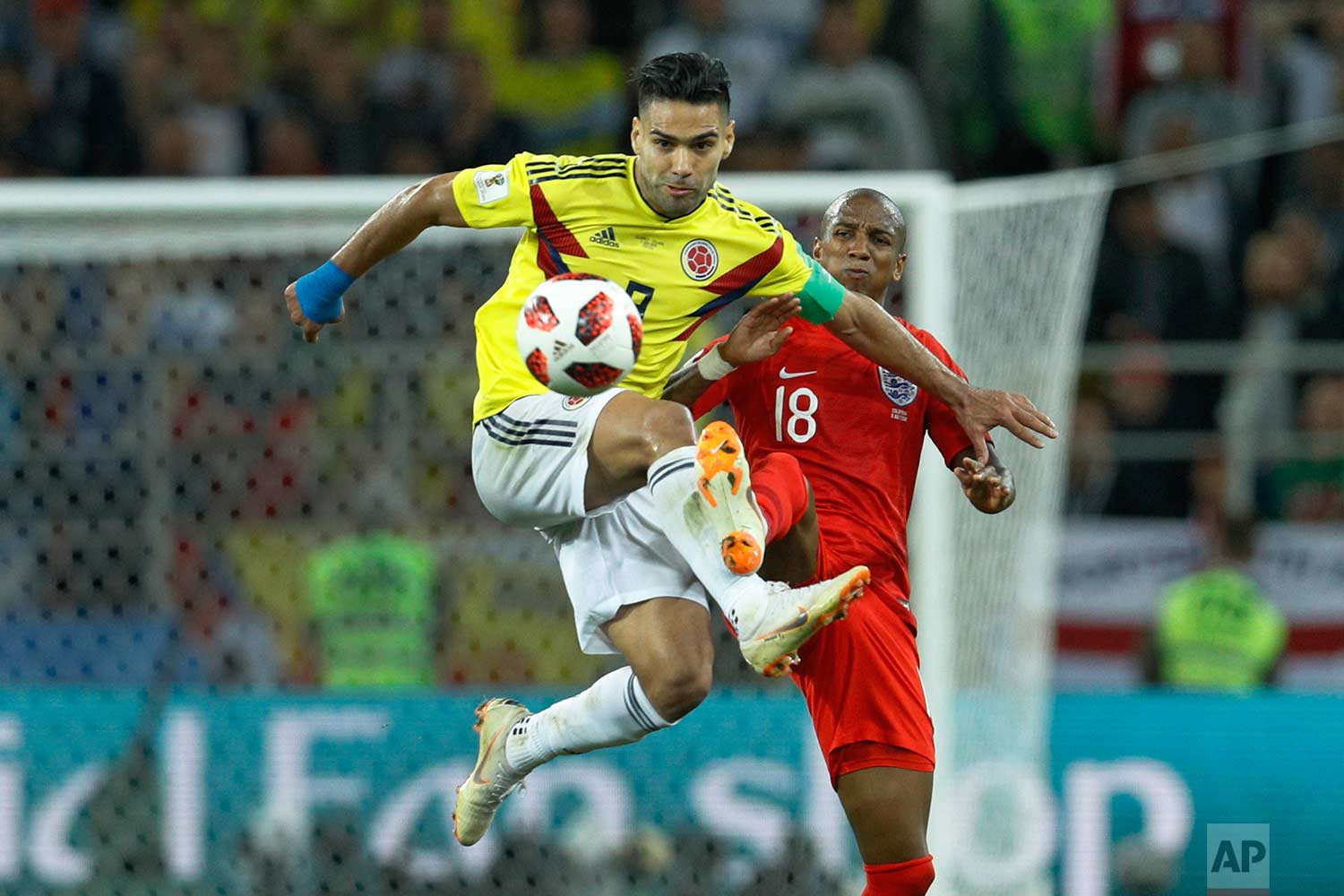 Colombia's Radamel Falcao, left, vies for a ball with England's Ashley Young during the round of 16 match between Colombia and England at the 2018 soccer World Cup in the Spartak Stadium, in Moscow, Russia, Tuesday, July 3, 2018. (AP Photo/Victor R. Caivano)