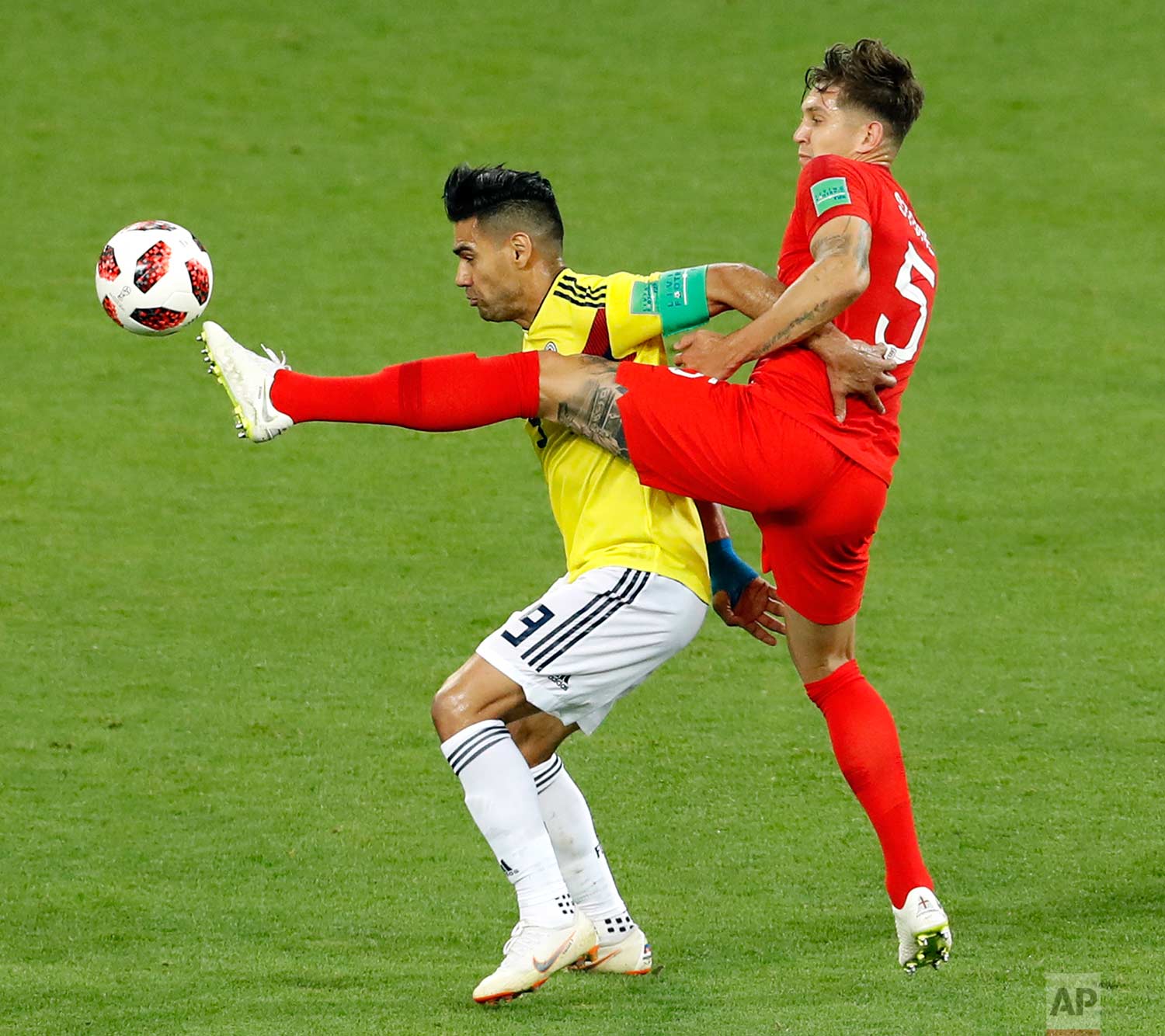  Colombia's Radamel Falcao fights for the ball with England's John Stones, right, during the round of 16 match between Colombia and England at the 2018 soccer World Cup in the Spartak Stadium, in Moscow, Russia, Tuesday, July 3, 2018. (AP Photo/Anton