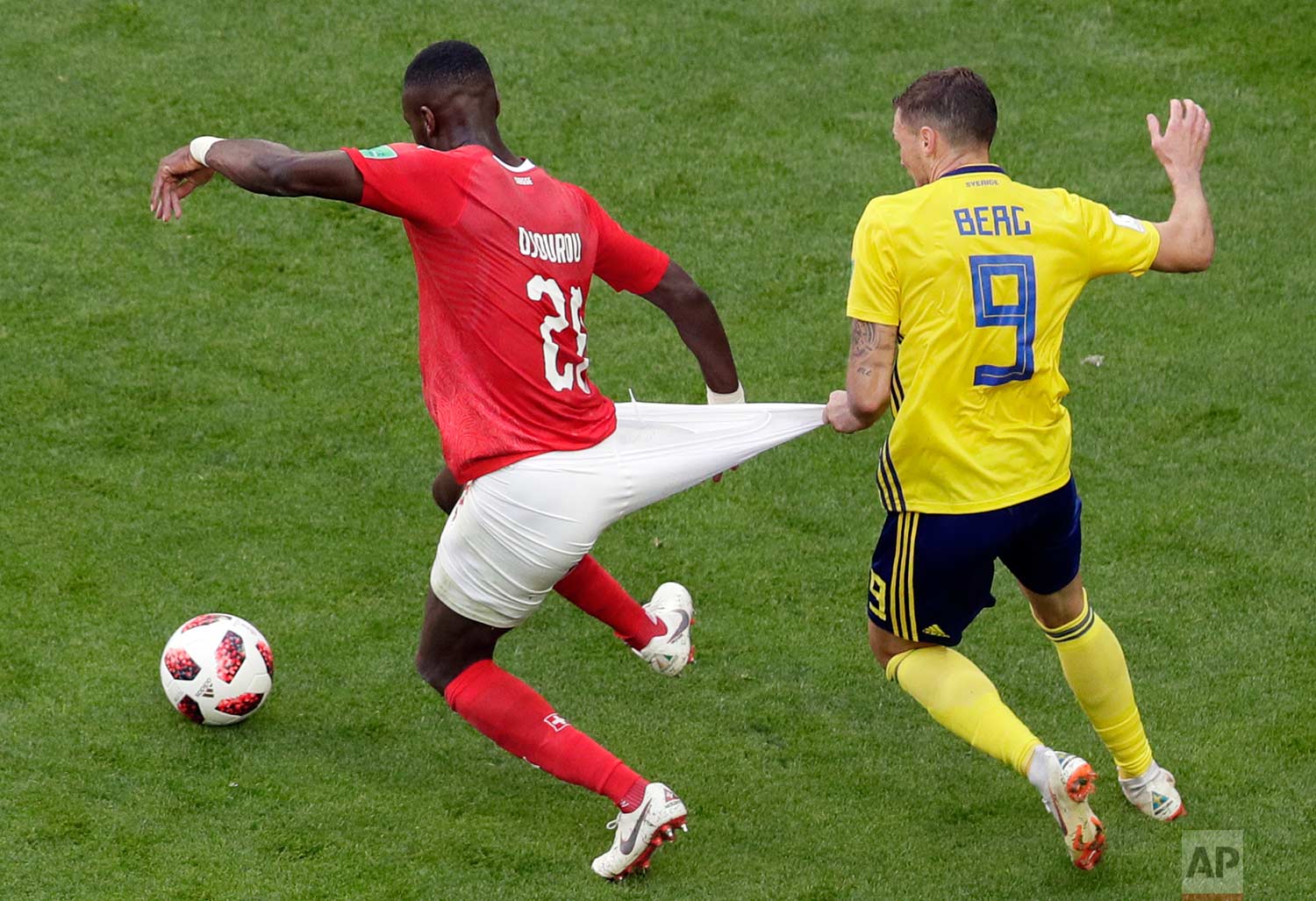  Switzerland's Johan Djourou, left, duels for the ball with Sweden's Marcus Berg during the round of 16 match between Switzerland and Sweden at the 2018 soccer World Cup in the St. Petersburg Stadium, in St. Petersburg, Russia, Tuesday, July 3, 2018.