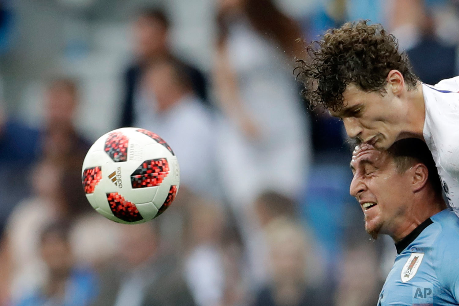  France's Benjamin Pavard, top, and Uruguay's Cristian Rodriguez challenge for the ball during the quarterfinal match between Uruguay and France at the 2018 soccer World Cup in the Nizhny Novgorod Stadium, in Nizhny Novgorod, Russia, Friday, July 6, 