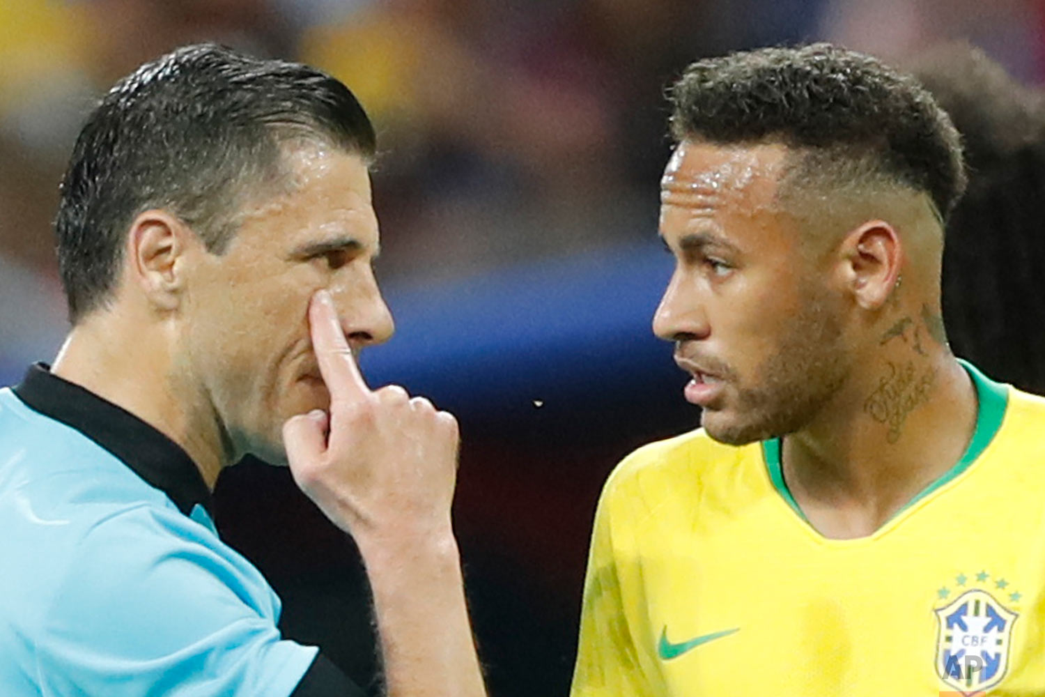 Referee Milorad Mazic from Serbia, left, gestures as he speaking to Brazil's Neymar during the quarterfinal match between Brazil and Belgium at the 2018 soccer World Cup in the Kazan Arena, in Kazan, Russia, Friday, July 6, 2018. (AP Photo/Frank Augstein)