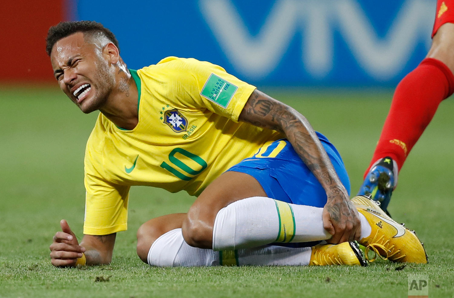 Brazil's Neymar holds his shinbone during the quarterfinal match between Brazil and Belgium at the 2018 soccer World Cup in the Kazan Arena, in Kazan, Russia, Friday, July 6, 2018. (AP Photo/Francisco Seco)