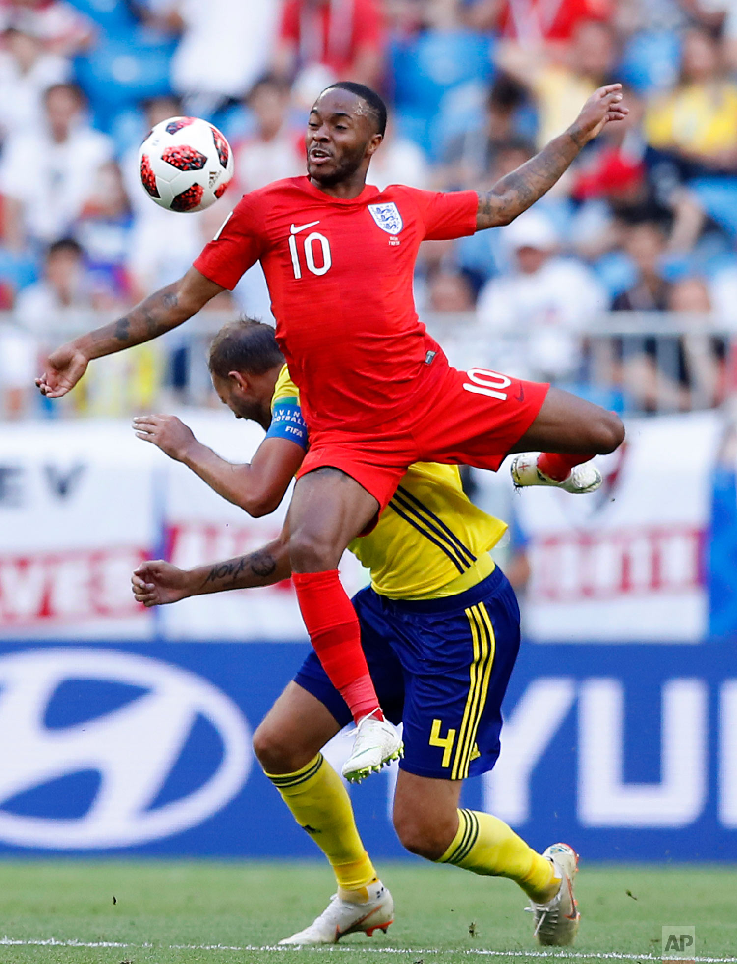  England's Raheem Sterling, top, challenges for the ball with Sweden's Andreas Granqvist during the quarterfinal match between Sweden and England at the 2018 soccer World Cup in the Samara Arena, in Samara, Russia, Saturday, July 7, 2018. (AP Photo/A