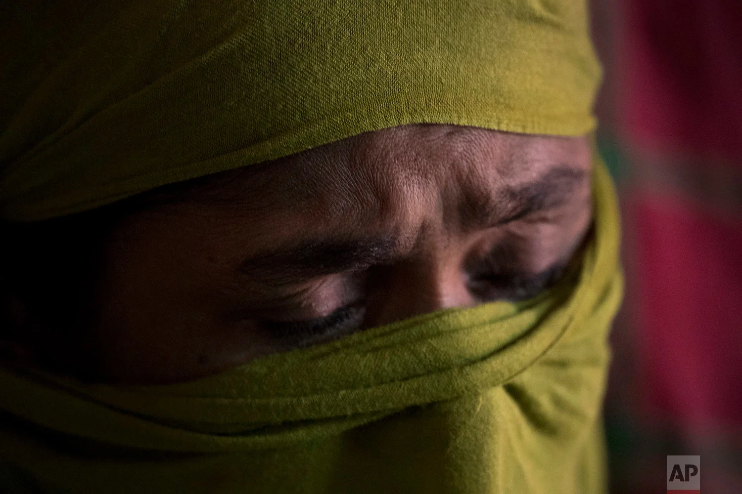 "D" recounts her experience of the rape she endured being so severe that she had to wrap a supportive scarf around her battered pelvis to endure the days long walk to Bangladesh, in her shelter in Kutupalong refugee camp, Bangladesh, June 25, 2018. (AP Photo/Wong Maye-E)