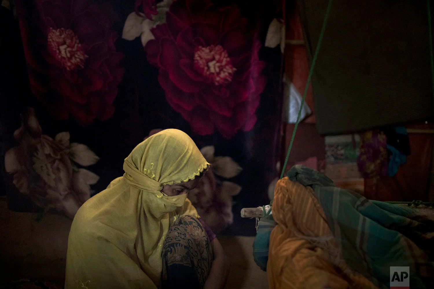 "M," who says that her life is meaningless, sits in her shelter in Kutupalong refugee camp in Bangladesh, June 26, 2018. (AP Photo/Wong Maye-E)