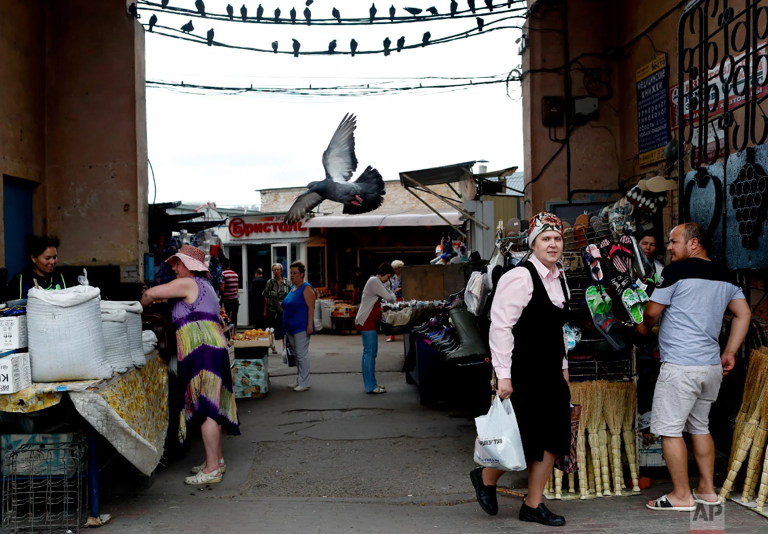 A woman walks out a market during the 2018 soccer World Cup in Nizhny Novgorod, Russia on Saturday, July 7, 2018. (AP Photo/Natacha Pisarenko)