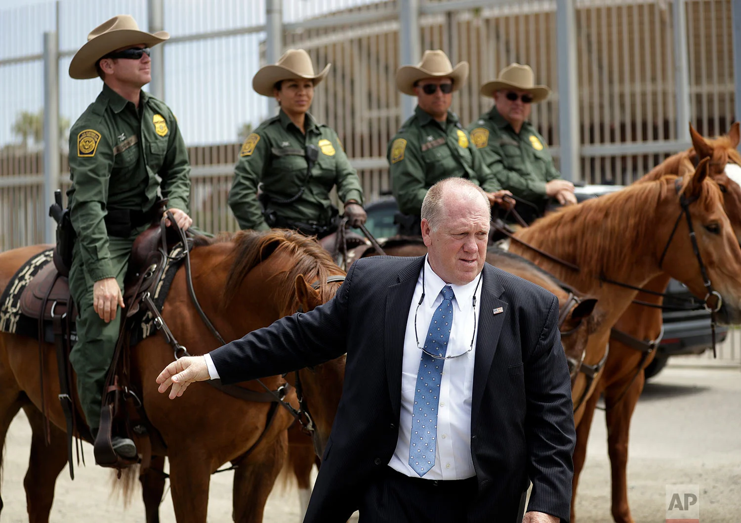 Thomas Homan, the recently retired acting director of U.S. Immigration and Customs Enforcement, greets border patrol agents along the border with Tijuana, Mexico, in San Diego. (AP Photo/Gregory Bull)