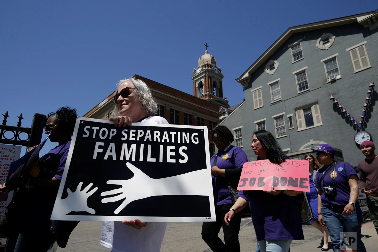 People march in support of immigrants during a May Day rally in Cincinnati. (AP Photo/Gregory Bull)