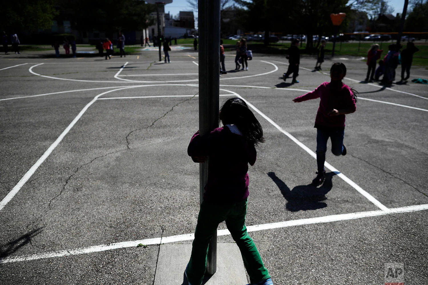 Children play at recess at John G. Carlisle Elementary School in Covington, Ky., on April 27, 2018. At least three students here had a parent arrested in December when ICE agents arrested people in Covington and four other cities. (AP Photo/Gregory Bull)