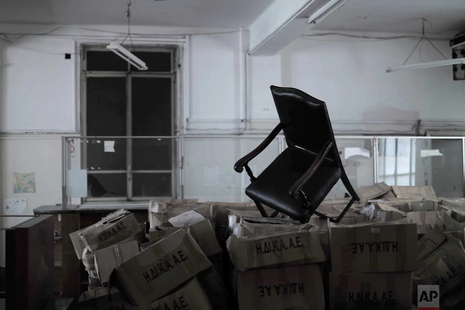 A chair is placed above boxes containing paper files in a 2,600-square meter listed building from 1955, formerly used by a commerce fund company. (AP Photo/Petros Giannakouris)