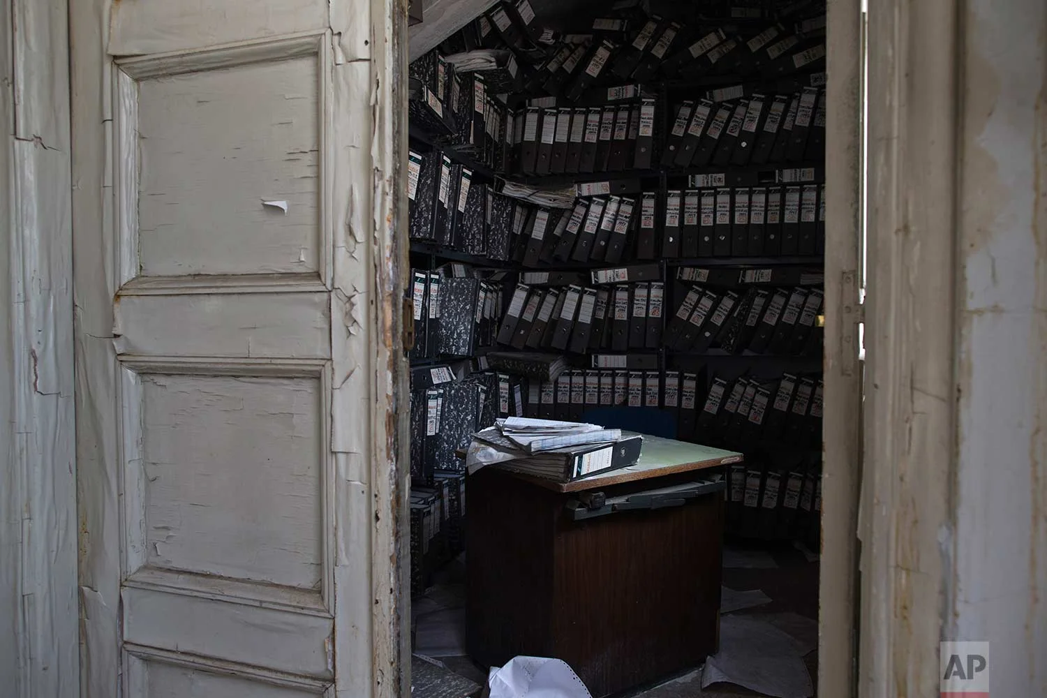 Shelves of paper files are stacked in an office of a 2,600-square meter listed building from 1955, formerly used by a commerce fund company. (AP Photo/Petros Giannakouris)