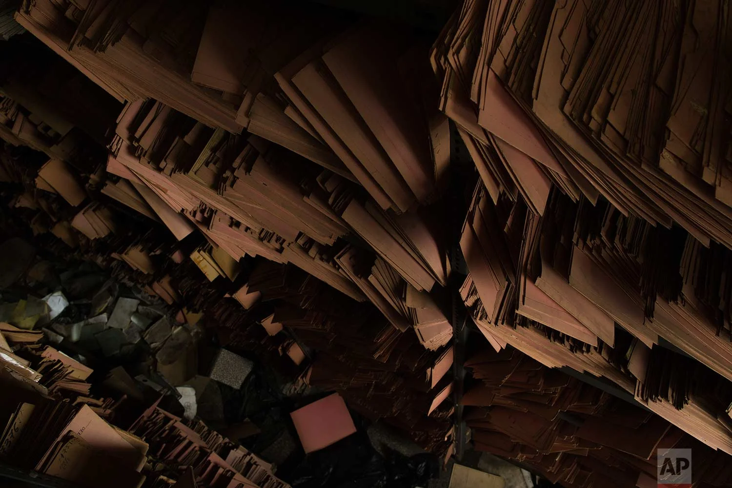 Shelves of paper files are stacked in a 2,600-square meter listed building from 1955, formerly used by a commerce fund company. (AP Photo/Petros Giannakouris)