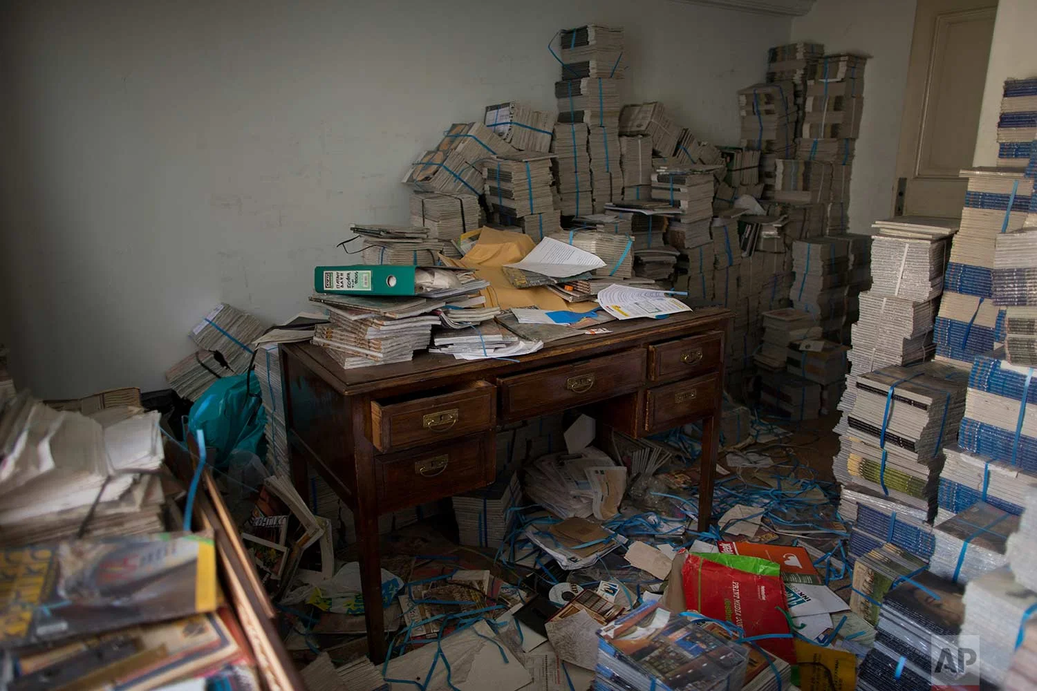 Stacks of magazines in an office in one of Athens' few substantial late 19th century buildings to survive brutal postwar development. (AP Photo/Petros Giannakouris)