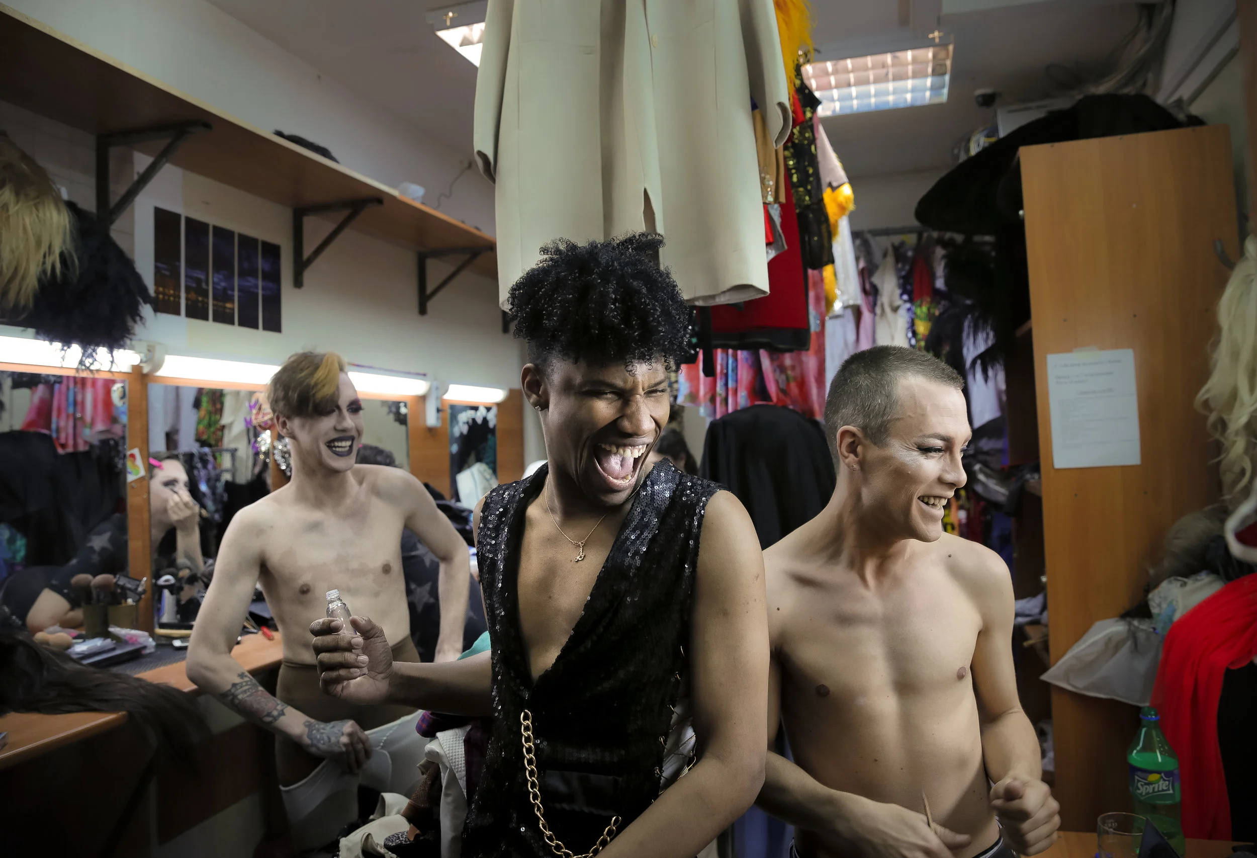 Andrei, or Star Vasha, right, Johan, center, and Dmitry, or Africa on stage, share a laugh during a break in the show at the Fame gay club, during the 2018 soccer World Cup in Yekaterinburg, Russia. (AP Photo/Vadim Ghirda)