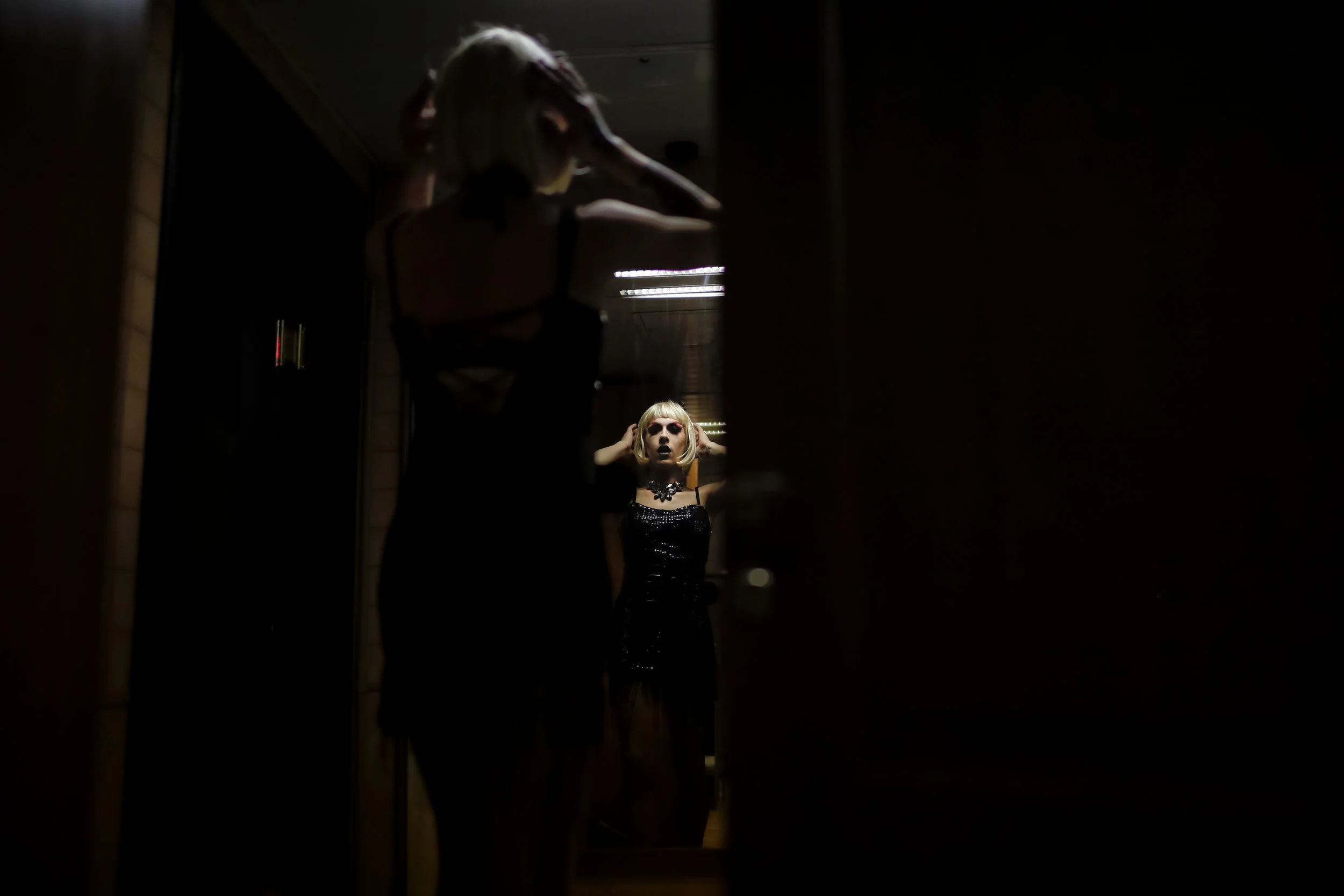 Dmitry, or Africa, on stage, checks an outfit at the Fame gay club, during the 2018 soccer World Cup in Yekaterinburg, Russia on June 24, 2018. (AP Photo/Natacha Pisarenko)