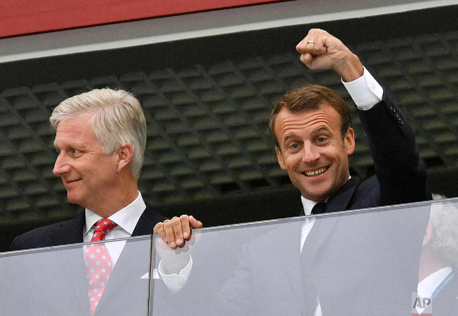 French President Emmanuel Macron, right, clenches a fist as he stands beside King Philippe of Belgium prior to the semifinal match between France and Belgium at the 2018 soccer World Cup in the St. Petersburg Stadium in St. Petersburg, Russia, Tuesday, July 10, 2018. (AP Photo/Martin Meissner)