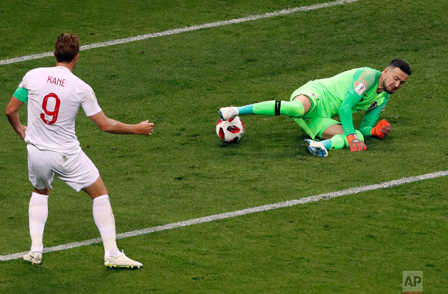  Croatia goalkeeper Danijel Subasic, right, makes a save in front of England's Harry Kane during the semifinal match between Croatia and England at the 2018 soccer World Cup in the Luzhniki Stadium in Moscow, Russia, Wednesday, July 11, 2018. (AP Pho