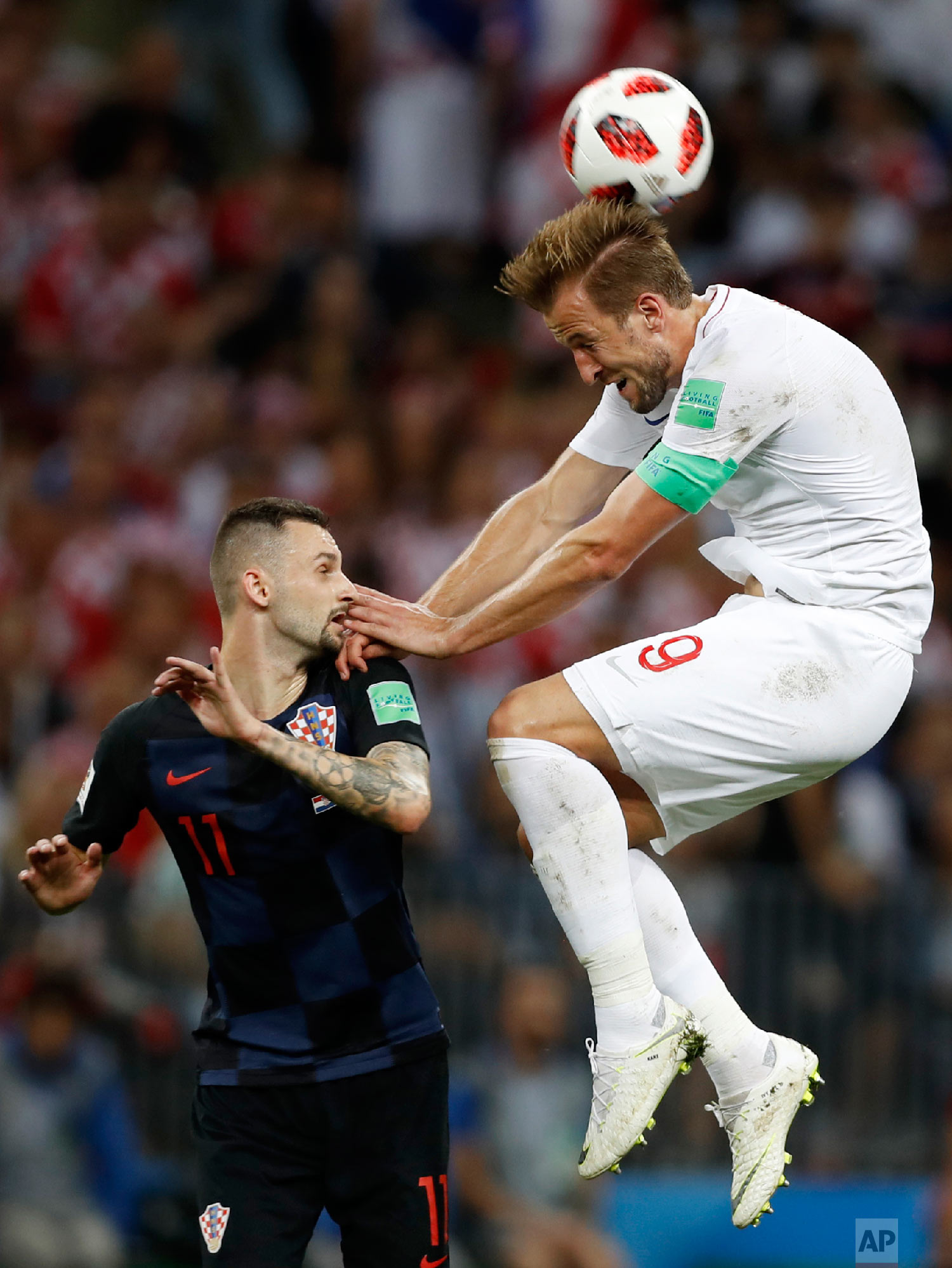  England's Harry Kane, right, challenges for the ball Croatia's Marcelo Brozovic, left, during the semifinal match between Croatia and England at the 2018 soccer World Cup in the Luzhniki Stadium in Moscow, Russia, Wednesday, July 11, 2018. (AP Photo