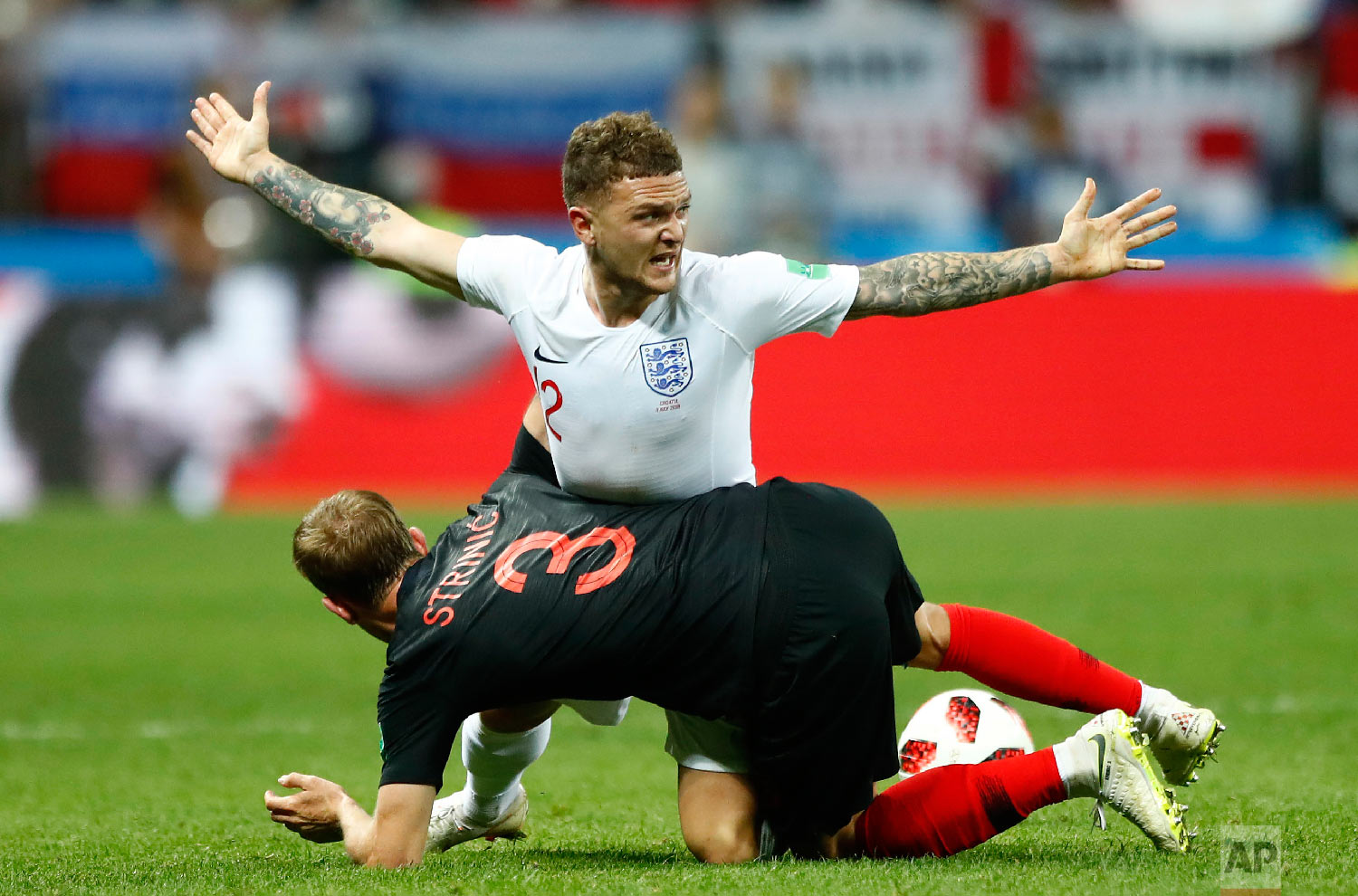  England's Kieran Trippier, up, and Croatia's Ivan Strinic challenge for the ball during the semifinal match between Croatia and England at the 2018 soccer World Cup in the Luzhniki Stadium in Moscow, Russia, Wednesday, July 11, 2018. (AP Photo/Matth
