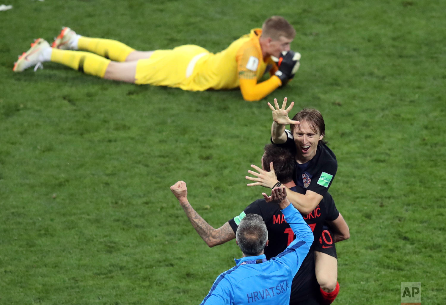  Croatia's Luka Modric, right, celebrates next to England goalkeeper Jordan Pickford, on the ground, at the end of the semifinal match between Croatia and England at the 2018 soccer World Cup in the Luzhniki Stadium in Moscow, Russia, Wednesday, July