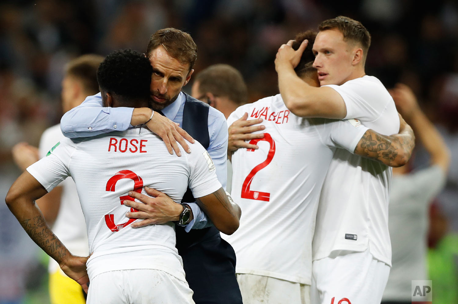  England head coach Gareth Southgate, 2nd left, comforts England's Danny Rose, left, after loosing the semifinal match between Croatia and England at the 2018 soccer World Cup in the Luzhniki Stadium in Moscow, Russia, Wednesday, July 11, 2018. (AP P
