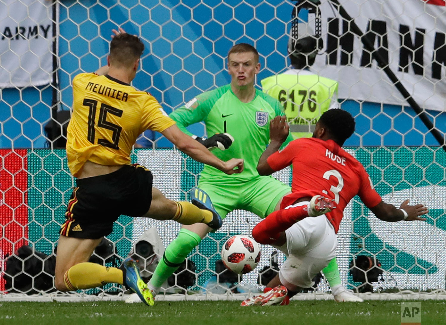 Belgium's Thomas Meunier, left, scores his side's opening goal against England goalkeeper Jordan Pickford as England's Danny Rose tries to defend during the third place match between England and Belgium at the 2018 soccer World Cup in the St. Petersburg Stadium in St. Petersburg, Russia, Saturday, July 14, 2018. (AP Photo/Petr David Josek)