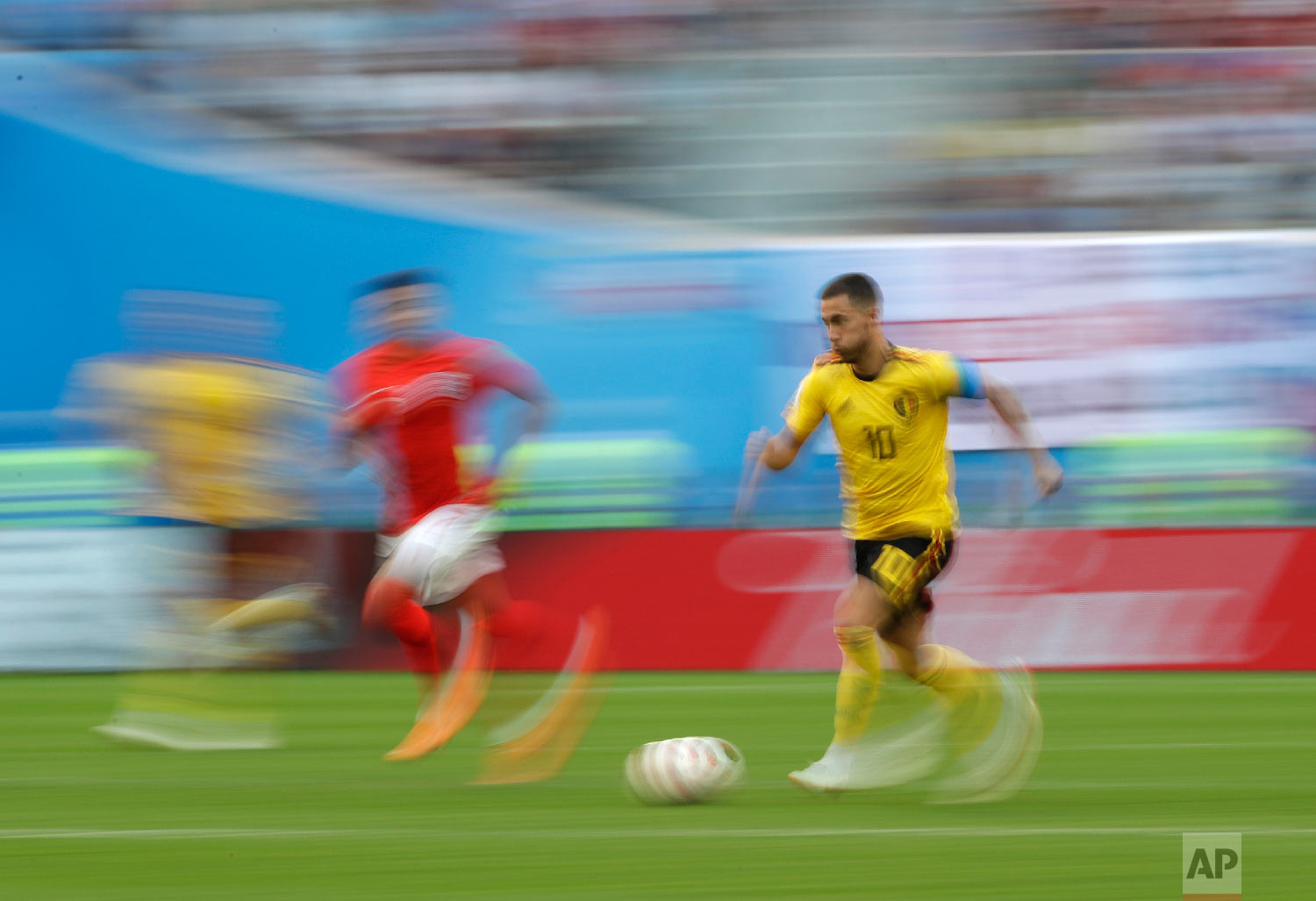  Belgium's Eden Hazard, right, is pursued by England's Jesse Lingard as he runs with the ball during the third place match between England and Belgium at the 2018 soccer World Cup in the St. Petersburg Stadium in St. Petersburg, Russia, Saturday, Jul