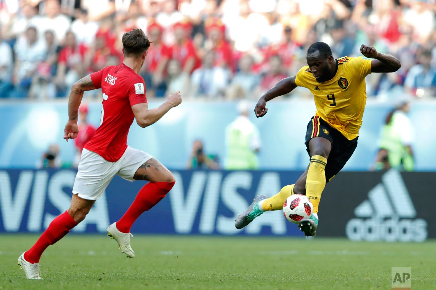 Belgium's Romelu Lukaku, right, controls the ball besides England's John Stones during the third place match between England and Belgium at the 2018 soccer World Cup in the St. Petersburg Stadium in St. Petersburg, Russia, Saturday, July 14, 2018. (AP Photo/Natacha Pisarenko)
