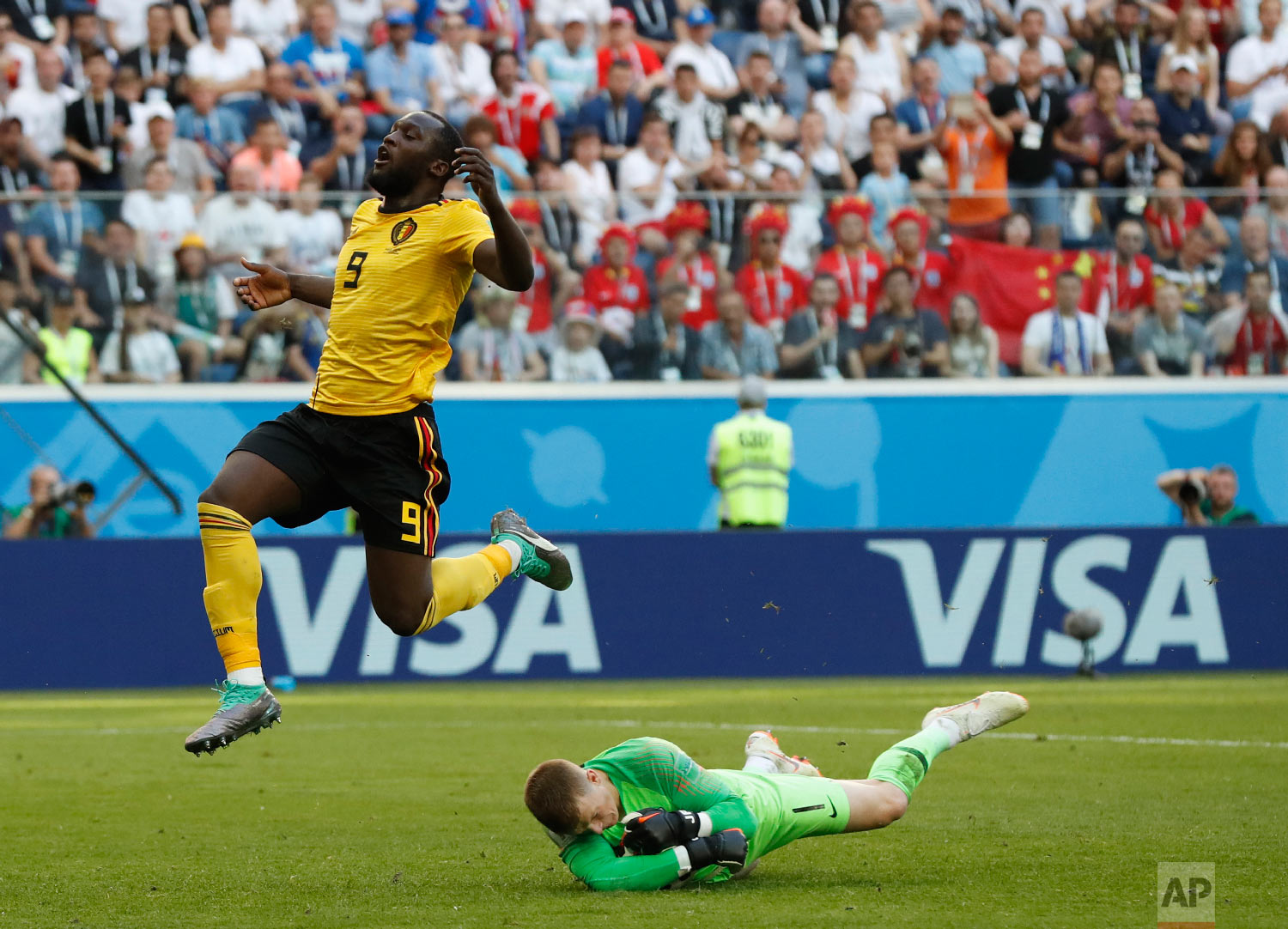  England goalkeeper Jordan Pickford stops a scoring attempt by Belgium's Romelu Lukaku during the third place match between England and Belgium at the 2018 soccer World Cup in the St. Petersburg Stadium in St. Petersburg, Russia, Saturday, July 14, 2
