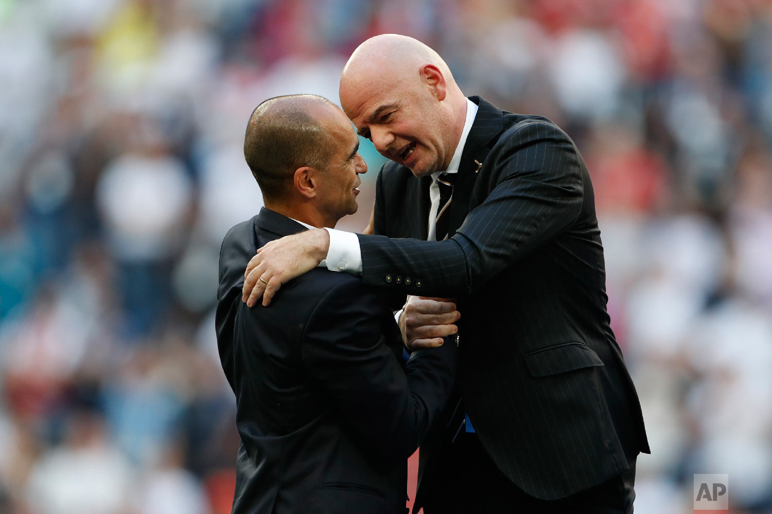  FIFA President Gianni Infantino, right, talks to Belgium coach Roberto Martinez after the third place match between England and Belgium at the 2018 soccer World Cup in the St. Petersburg Stadium in St. Petersburg, Russia, Saturday, July 14, 2018. (A