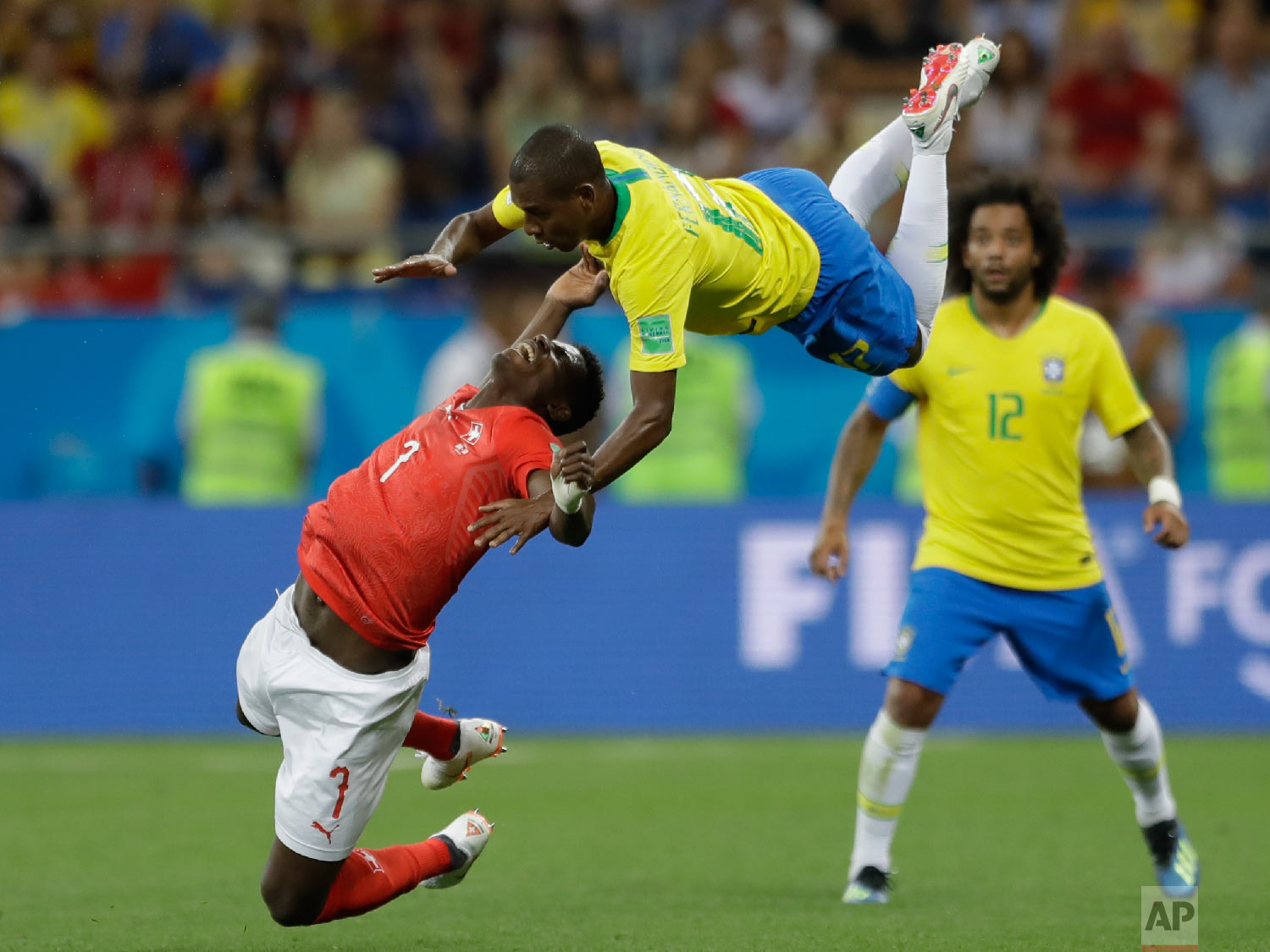 Switzerland's Breel Embolo, left, and Brazil's Fernandinho fall during the group E match between Brazil and Switzerland at the 2018 soccer World Cup in the Rostov Arena in Rostov-on-Don, Russia on June 17, 2018. (AP Photo/Andre Penner)
