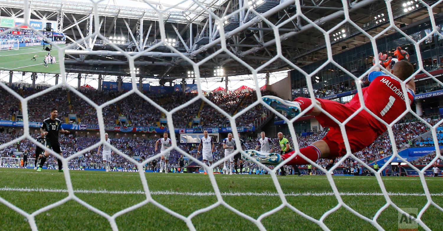 Iceland goalkeeper Hannes Halldorsson, right, saves a penalty by Argentina's Lionel Messi during the group D match between Argentina and Iceland at the 2018 soccer World Cup in the Spartak Stadium in Moscow, Russia on June 16, 2018. (AP Photo/Antonio Calanni)