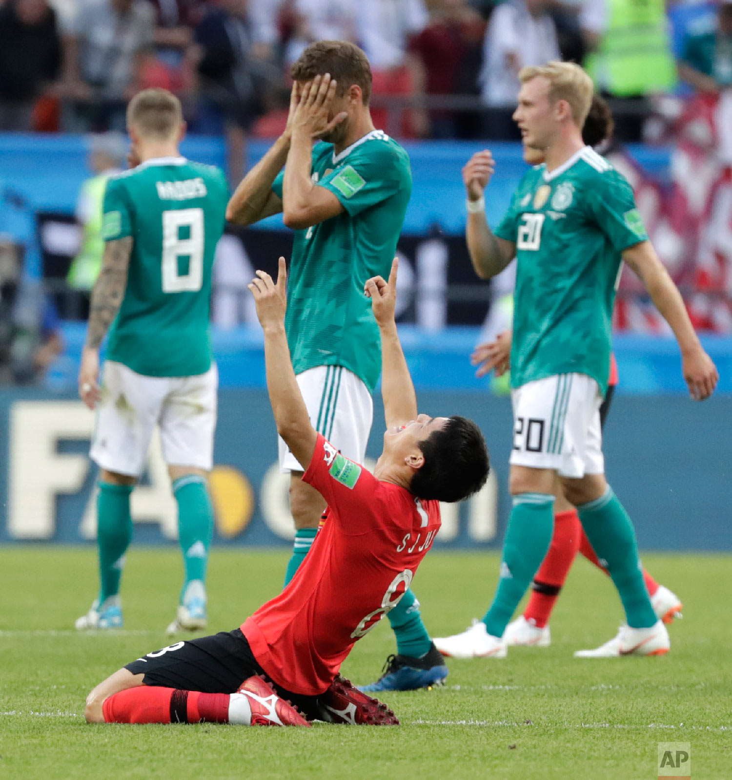  Germany's players walk off the pitch as South Korea's Ju Se-jong, front celebrates after the group F match between South Korea and Germany, at the 2018 soccer World Cup in the Kazan Arena in Kazan, Russia on June 27, 2018. (AP Photo/Lee Jin-man) 