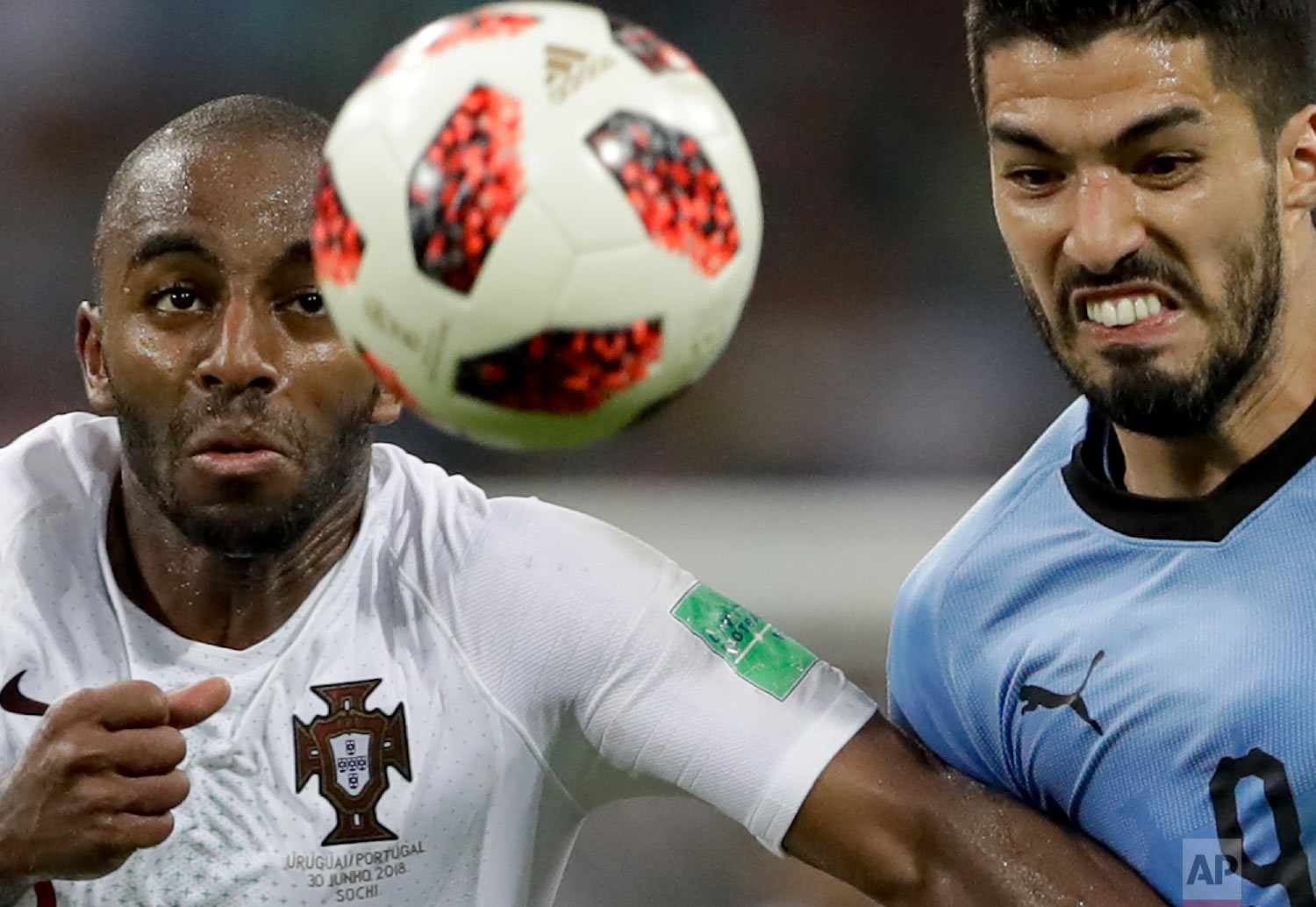 Uruguay's Luis Suarez, right, challenges for the ball with Portugal's Ricardo during the round of 16 match between Uruguay and Portugal at the 2018 soccer World Cup at the Fisht Stadium in Sochi, Russia on June 30, 2018. (AP Photo/Andre Penner)