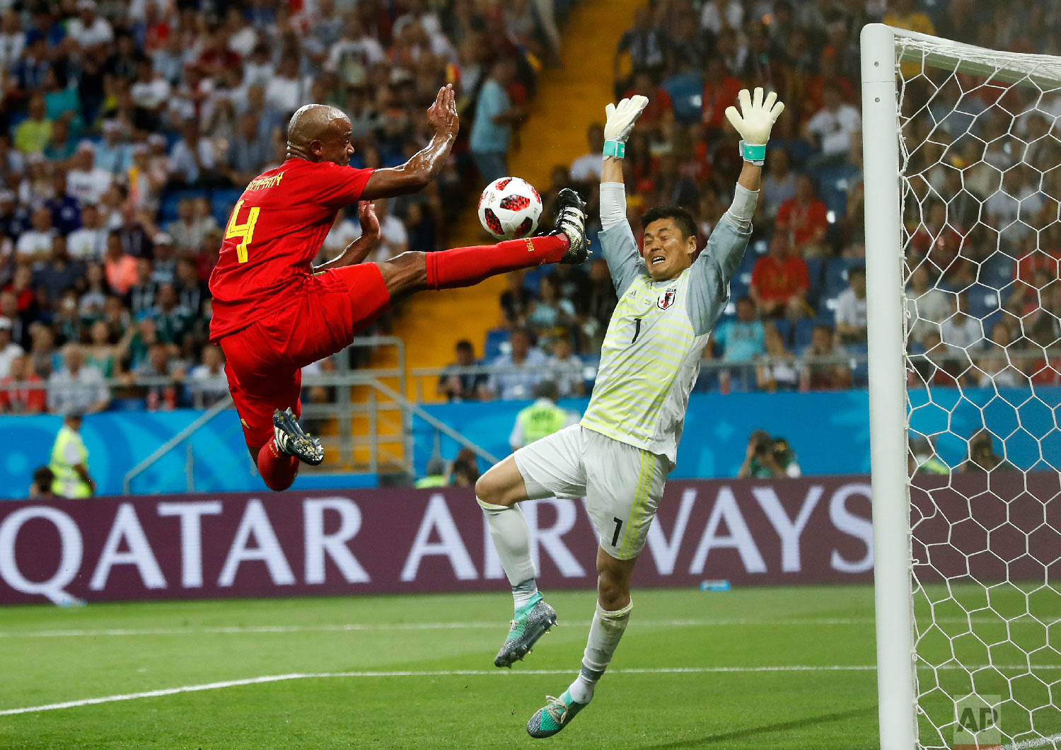Belgium's Vincent Kompany jumps for the ball in front of Japan goalkeeper Eiji Kawashima during the round of 16 match between Belgium and Japan at the 2018 soccer World Cup in the Rostov Arena, in Rostov-on-Don, Russia on July 2, 2018. (AP Photo/Petr David Josek)