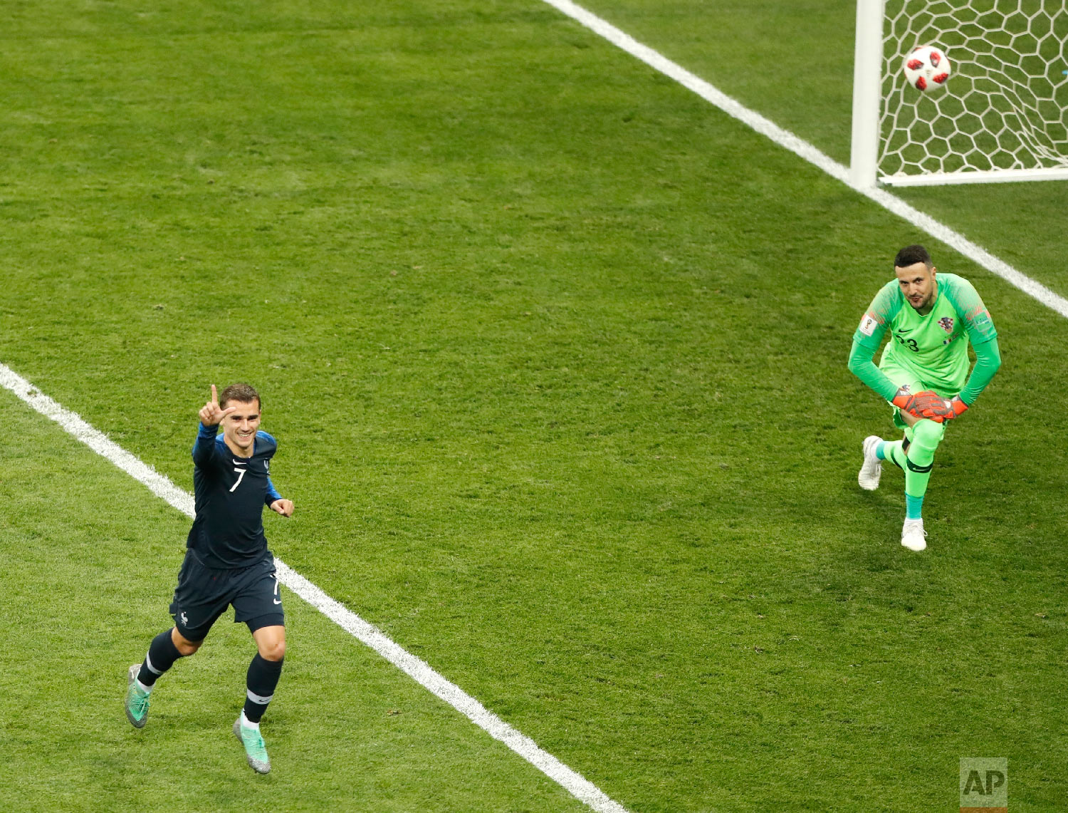 France's Antoine Griezmann, right, celebrates after scoring a penalty kick during the final match between France and Croatia at the 2018 soccer World Cup in the Luzhniki Stadium in Moscow, Russia, Sunday, July 15, 2018. (AP Photo/Frank Augstein)