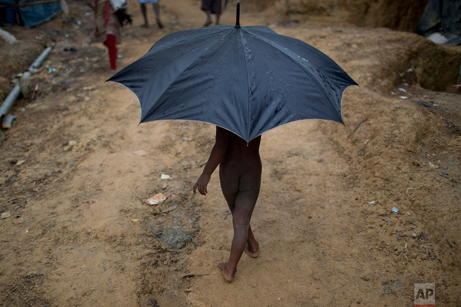 In this Monday, June 25, 2018, file photo, a Rohingya child refugee carries an umbrella as he walks through Kutupalong refugee camp in Bangladesh. (AP Photo/Wong Maye-E) 