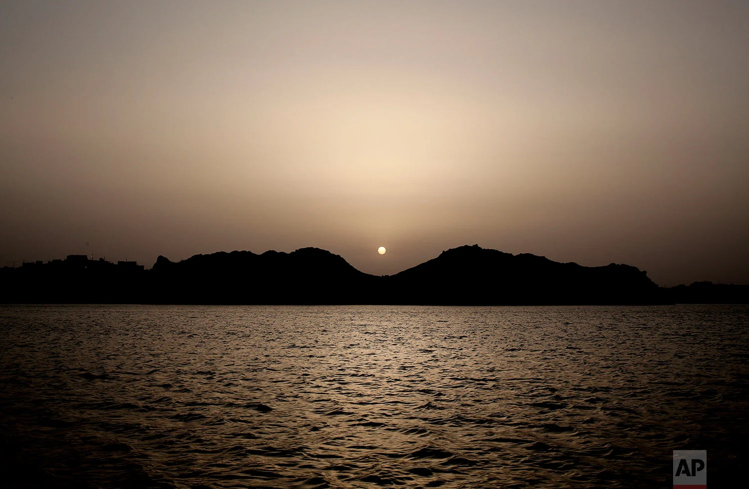 The sun sets near Heisa Island, Aswan, Egypt. (AP Photo/Nariman El-Mofty)