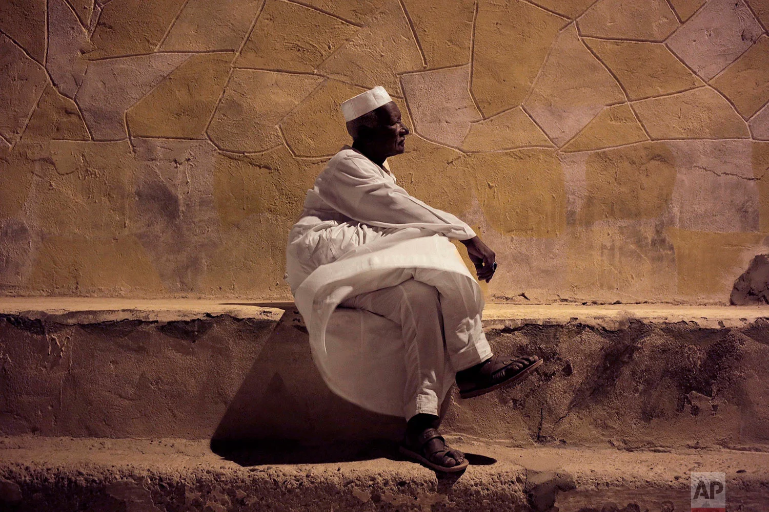 65-year old Mohammed Haroun sits in front of his home in Wadi Karkar, a new complex under construction in the desert west of Lake Nasser, Aswan, Egypt. (AP Photo/Nariman El-Mofty)