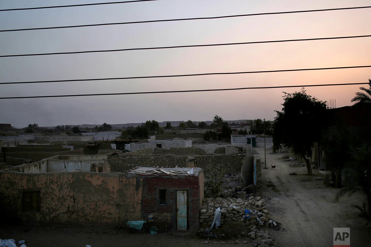 The sun sets in "tahgeer" Eneiba village, northern Aswan, Egypt. (AP Photo/Nariman El-Mofty)