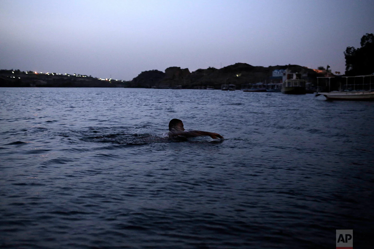 A Nubian man swims in the Nile River on Heisa Island, in Aswan, Egypt. (AP Photo/Nariman El-Mofty)