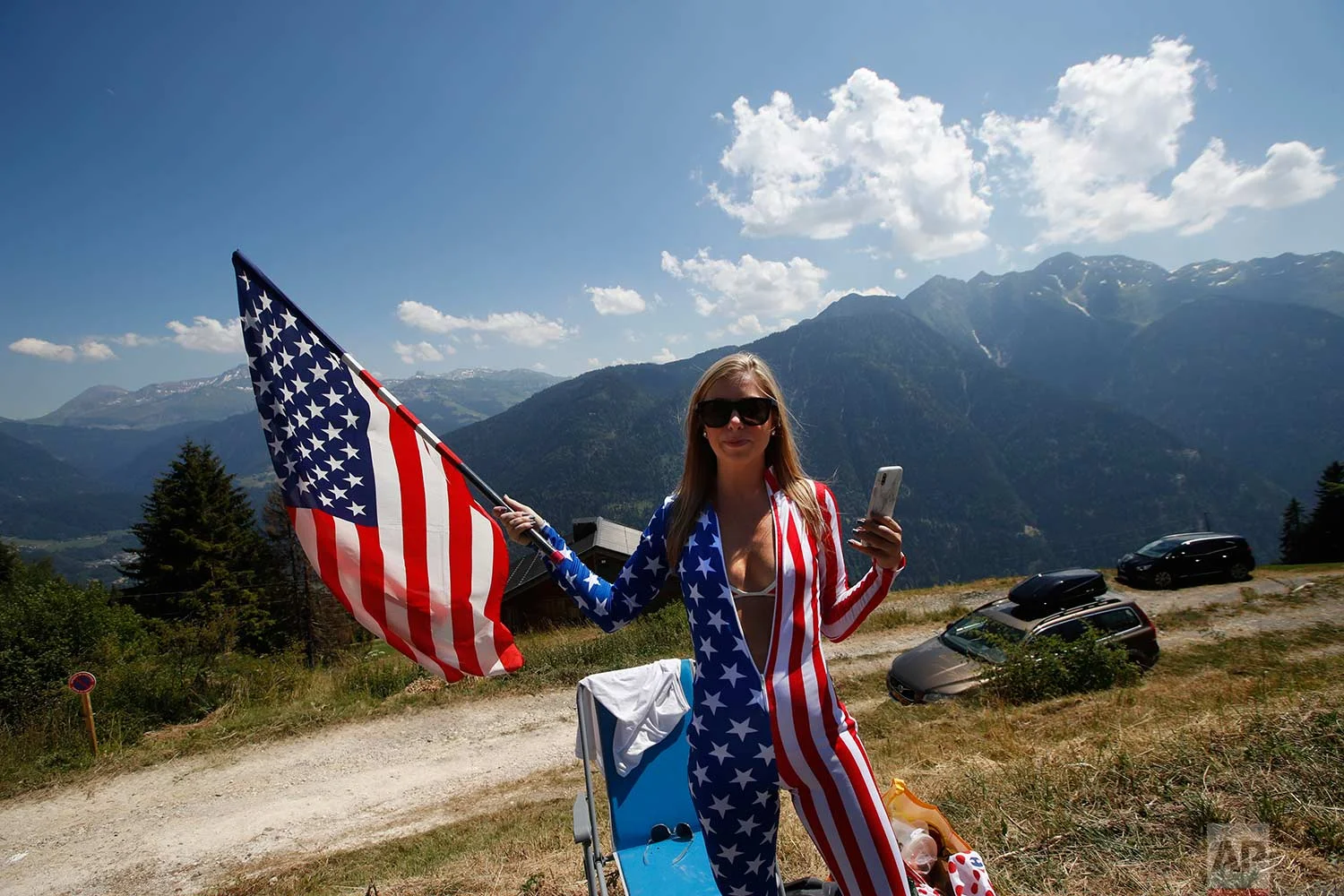 A cycling fan waits on the side of the road for riders to pass during the eleventh stage of the Tour de France cycling race over 108.5 kilometers (67.4 miles) with start in Albertville and finish in La Rosiere Espace San Bernardo, France. (AP Photo/Christophe Ena )