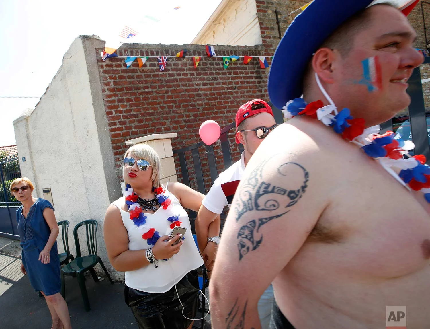 Spectators wait for the pack to pass during the ninth stage of the Tour de France cycling race over 156.5 kilometers (97.2 miles) with start in Arras and finish in Roubaix, France, Sunday, July 15, 2018. (AP Photo/Christophe Ena)